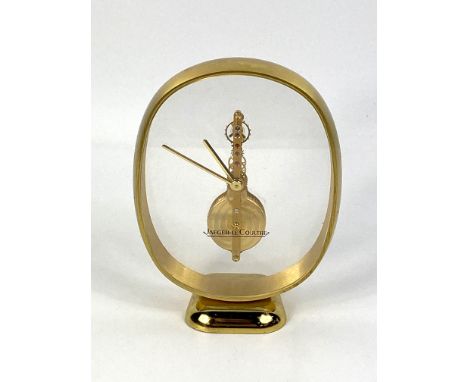 A brass and glass faced Jaeger Lecoultre wind up skeleton clock, serial number to the underside " 3 215 015 1 " Swiss made, i