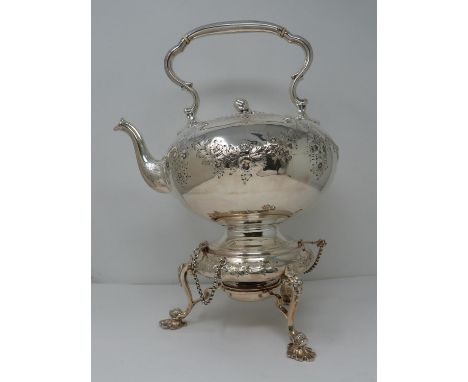 An antique white metal and ivory spirit kettle and stand. The kettle has a flower bud finial and engraved floral details. The