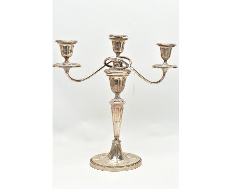 A GEORGE V SILVER THREE LIGHT CANDELABRUM OF NEO-CLASSICAL STYLE, the oval removable sconces and drip pans with beaded rims, 