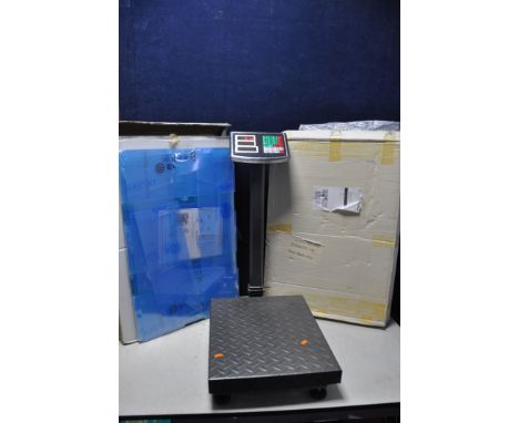 TWO PLASTIC SLOT CAR DISPLAY CABINETS, unused/unopened, along with a set of metal folding platform scales (3)