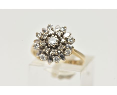 A YELLOW METAL DIAMOND CLUSTER RING, flower shape cluster, set with round brilliant cut and single cut diamonds, stamped diam