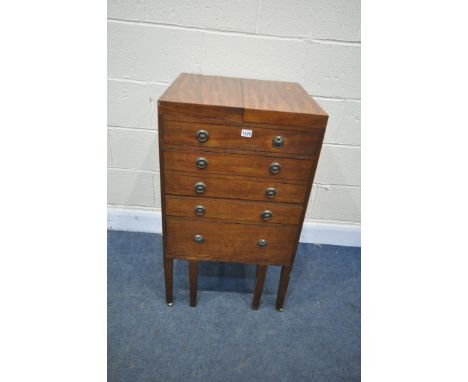 A GEORGIAN MAHOGANY GENTLEMANS WASHSTAND, the double flap top enclosing an arrangement of pigeon holes, and adjustable mirror