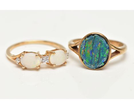 TWO OPAL RINGS, the first designed with two claw set, oval cut opal cabochons, interspaced with round brilliant cut diamonds,