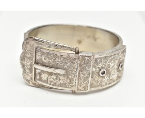 A SILVER HINGED BANGLE, in the form of a belt and buckle, decorated with a floral pattern, hallmarked 'T H Ltd' Birmingham 19