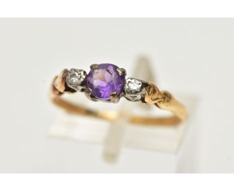 A YELLOW METAL AMETHYST AND DIAMOND RING, centring on a claw set, circular cut amethyst, flanked with single cut diamonds, to