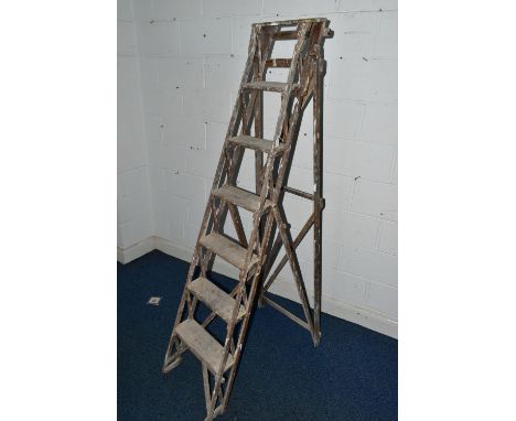 A SET OF VINTAGE WOODEN STEP LADDERS, bearing cast iron 'TRADE MARK CAJAC' mounts to both sides, closed height 199cm (Conditi