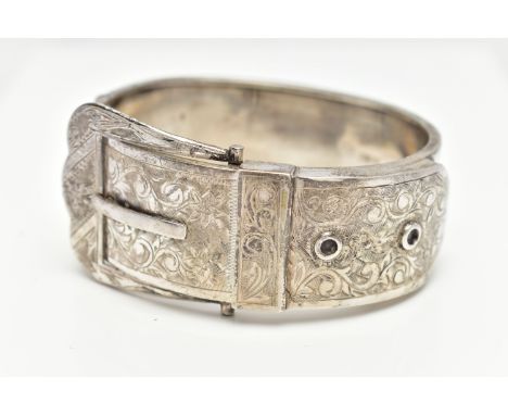 A SILVER HINGED BANGLE, in the form of belt and buckle, decorated with a floral pattern, hallmarked 'T H Ltd' Birmingham 1954