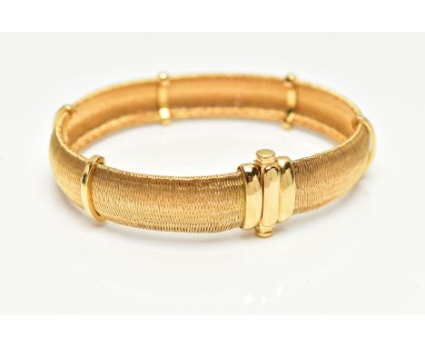 A YELLOW METAL ARTICULATED BRACELET, concaved bracelet, with polished spacers, fitted with an integrated push piece clasp, st