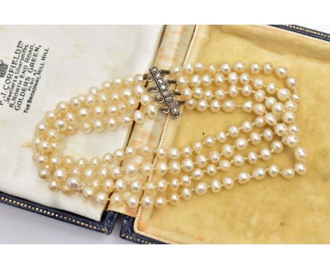 A CULTURED FRESH WATER PEARL BRACELET WITH DIAMOND SET CLASP, a four row cultured pearl bracelet, each pearl is individually 