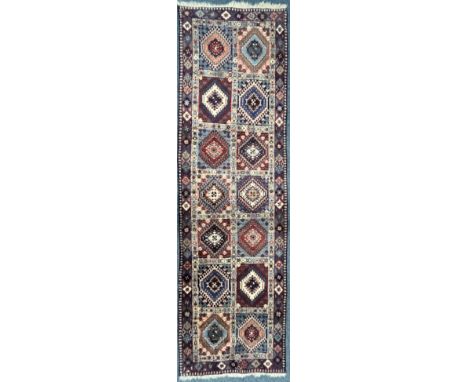 A 20TH PERSIAN CARPET RUNNER, with fourteen patterned lozenge, of various colours, 287cm x 84cm (condition:-good condition)