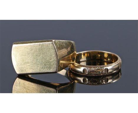 Two 18 carat gold rings, the first with a flat head, rign size V, together with a band with scroll design, ring size P, total