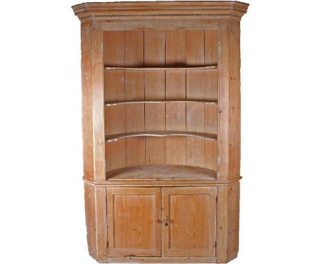 19th Century pine corner cabinet, with a concave cornice above a Greek key frieze, barrel back three shelf interior, above a 