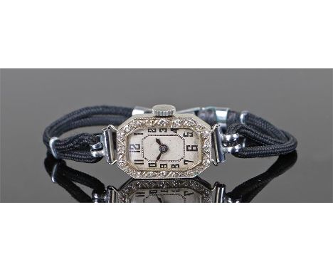 Early 20th Century ladies white metal wristwatch, the case with stones set to the edge, rectangular dial with Arabic hours, m