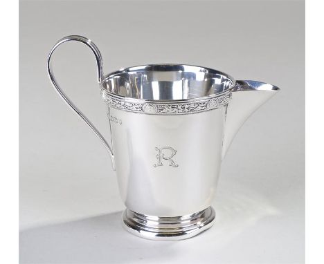 George VI silver cream jug, Sheffield 1940, maker Edward Viner, the rim with a Celtic design border, looped handle and taperi