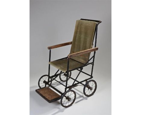 First World War 'Peero' invalid chair, the collapse-able frame with canvas seat and back, named foot rest, sprung wheels to t