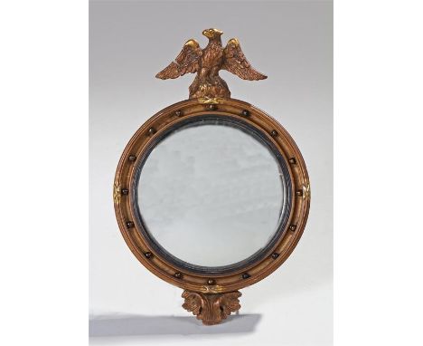 Gilt wood convex mirror, of small proportions, surmounted by an eagle above a convex mirror and ball finial border, shell bel