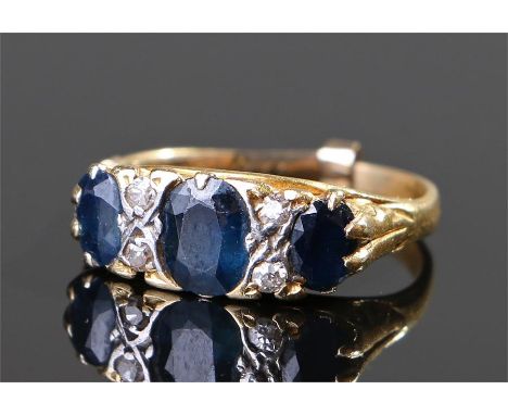 Yellow metal sapphire and diamond ring, with three sapphires and four diamonds, ring size K