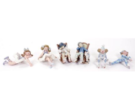 A PAIR OF LLADRO FIGURES OF A BOY AND GIRL IN ROCKING CHAIRS, 12CM H, IMPRESSED NUMBERS, PRINTED MARKS AND FOUR LLADRO FIGURE