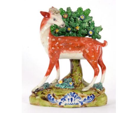A WALTON TYPE STAFFORDSHIRE PEARLWARE MODEL OF A DEER BEFORE BUCCAS, 18CM H, CIRCA 1830
