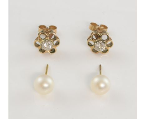 A pair of diamond set gold earrings in open flower setting, total diamond weight, 0.46 carat, and a pair of pearl studs .    