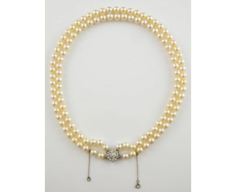 Cultured pearl necklace with diamond clasp, cluster of round brilliant cut diamonds, mounted in white metal testing as 18 ct,