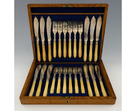 Set of twelve Victorian silver and ivory handled fish knives and forks with engraved scrolling decoration, by John Gilbert & 