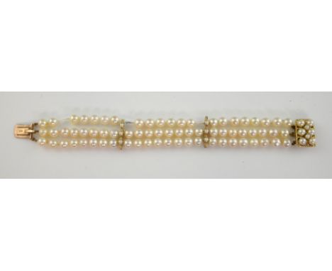 Cultured pearl three row bracelet, round white pearls measuring 6mm in diameter, with two pearl set bars, in yellow metal sta