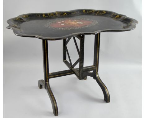 19th century papier mache folding table of serpentine form with tilt top, gilt, mother of pearl and painted floral decoration