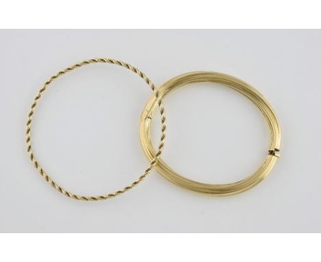 Two gold bangles, a hinged gold bangle 9 ct, and rope twist bangle tested as 14 ct .     9 ct 16.2 grams 14 ct 8.9 grams 