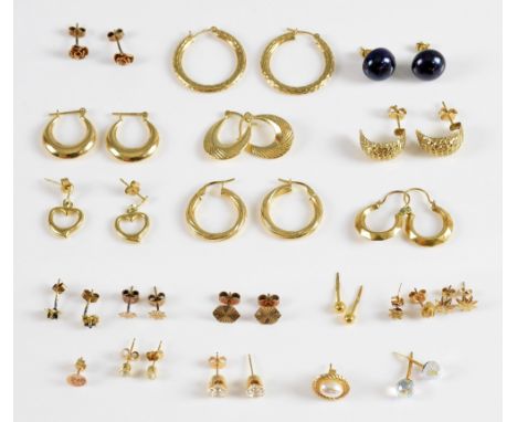 Group of gold earrings, hoops and studs .     Gold only items 16 grams pearl and gem set items 6.7 grams 