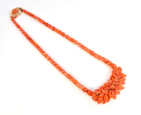 Mid 19th C coral necklace, central carved leaf and fruit panel, graduated beads, measuring 57cm in length, with coral and see