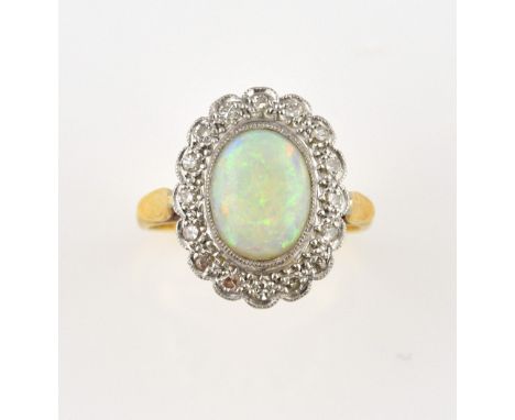 Opal and diamond cluster ring, oval cabochon cut opal, estimated weight 1.27 carats, set within a border of Swiss cut diamond