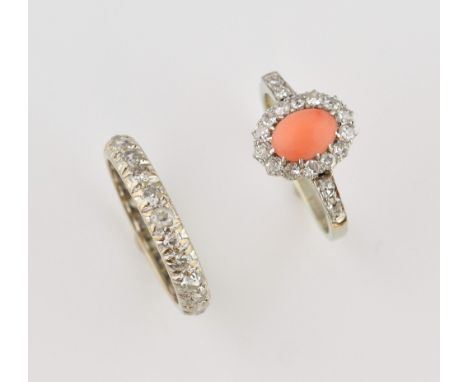 Vintage coral and diamond ring, oval cabochon cut coral, estimated weight 0.69 carat, set with in a border of Swiss diamonds,