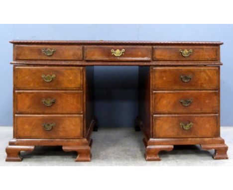 20th century  walnut pedestal desk of nine drawers on ogee bracket feet, 75cm x 140cm .     kneehole height - 61cm Leather ne