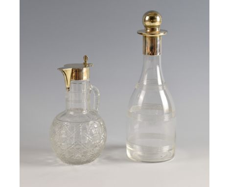 Silver collared glass decanter and a claret jug with silver mounts,.     