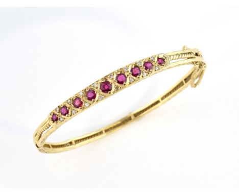 Victorian style gold bangle set with rubies and diamonds, in 9 ct gold, 6 cm inner width, with safety chain and figure of eig