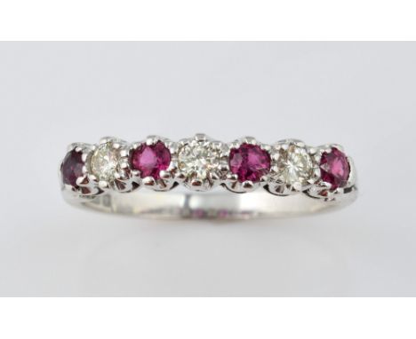 Ruby and diamond set half eternity ring, claw set in 18 ct white gold, ring size O  .     