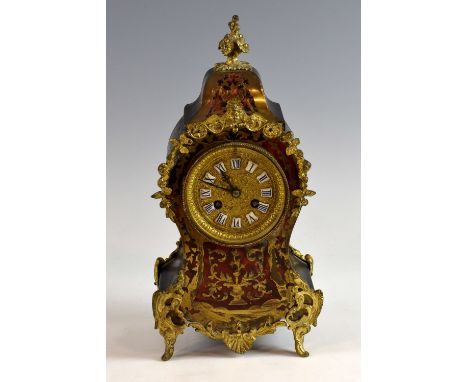 A Boulle-style mantel clock, cartouche shaped, with eight-day two train movement, enamelled Roman numerals, 32 cm high.     M