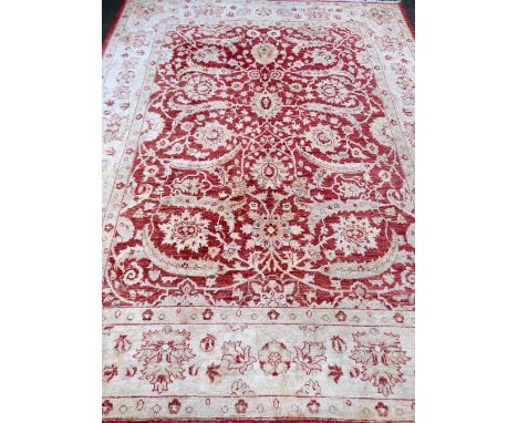 A Red ground Persian type carpet, 316 x 243 cms.     very faded throughout, some staining, loss of pile due to use. 