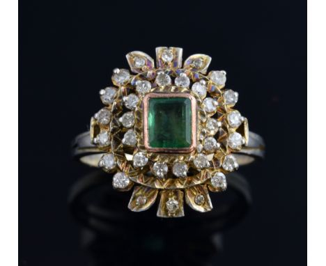 Emerald and diamond cluster ring, set with step cut emerald to the centre with a two row diamond cluster surround, mounted in