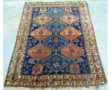 Persian Blue Ground Carpet with multiple floral borders, centre with repeating stepped lozenge shaped medallions, 155 x 200 c