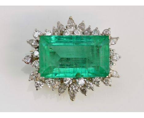 Large emerald and diamond set brooch with step cut emerald of good colour, 12.25 carat, within a border of round and marquise