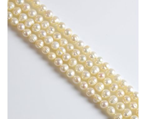 Opera length cultured pearl necklace, 7 - 7.5mm white baroque pearls, strung with knots, measuring approximately 108 cm in le