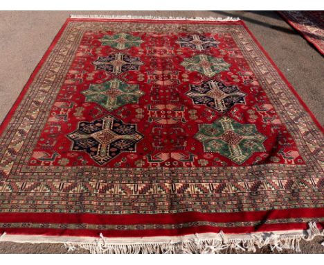 Persian type red ground carpet with multiple borders, the centre with repeating medallions 310cm x 240cm .     