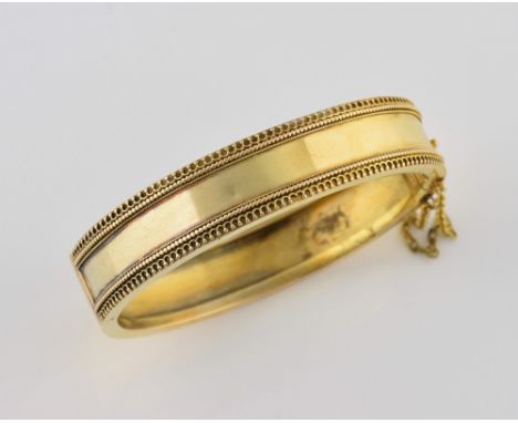 Victorian gold hinged bangle, with wire work decoration, and safety chain, in unmarked gold testing as 15 ct, with hidden cla