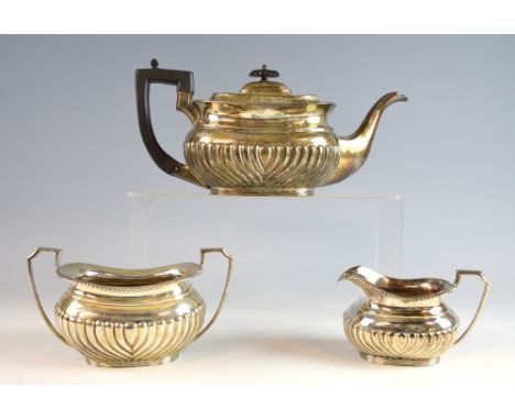 Victorian silver three-piece tea service, comprising teapot with ebonised wood handle and finial, cream jug and sugar bowl, a