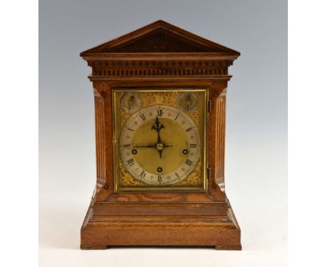 Oak cased triple train mantel clock, the silvered chapter ring with Roman and Arabic numerals, subsidiary seconds dial, chime