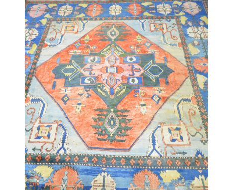 Large Persian design carpet, the blue ground with central lozenge and geometric borders. 470cm x 392cm.     Various fading th