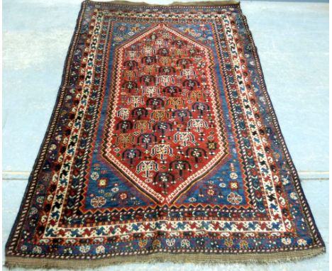 Persian style red ground carpet, lozenge shape central medallion, repeated stylised border, 168 x 240 cm .     