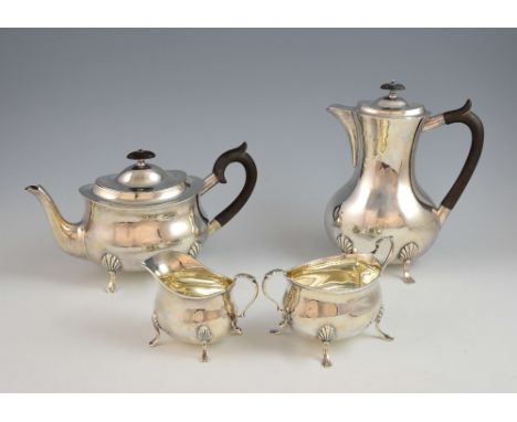 George V silver tea service of plain form, comprising tea pot, hot water jug, sugar bowl and cream jug, all on pad feet, by W